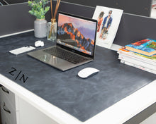 Navy blue full-grain leather desk mat in a workspace