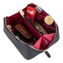 Open black leather makeup bag with divided interior and toiletries